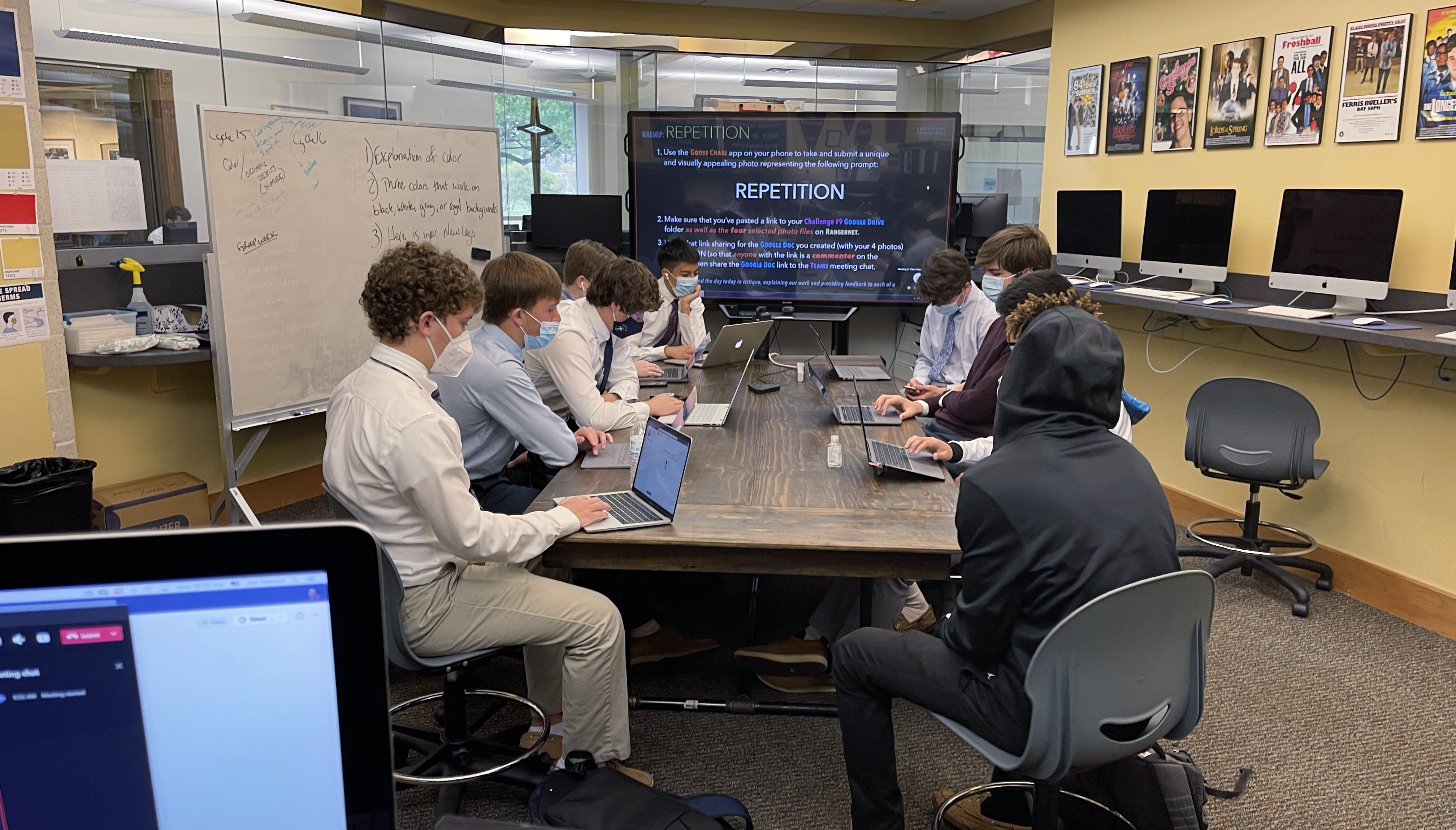 Jesuit Dallas yearbook students working together in the publications lab.